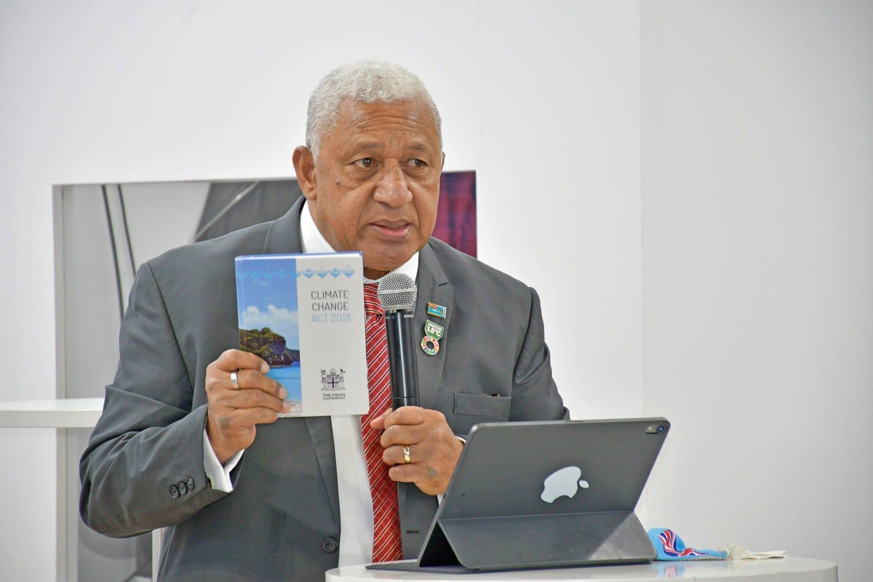 Fijian Prime Minister Voreqe Bainimarama with a copy of the Climate Change Act 2021. Picture: FIJI GOVT